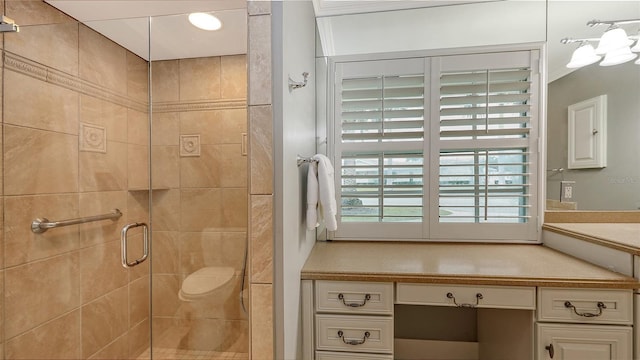 bathroom with a shower with shower door and vanity