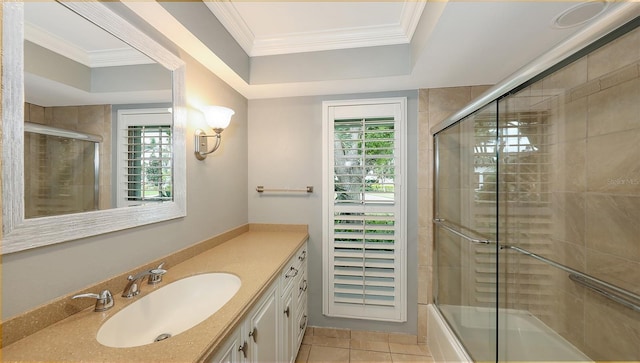 bathroom with vanity, tile patterned floors, a raised ceiling, enclosed tub / shower combo, and ornamental molding