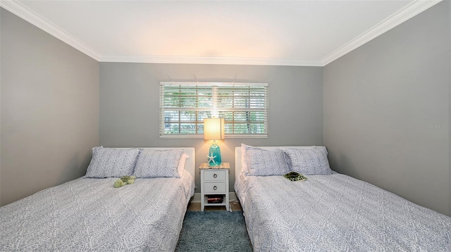 bedroom featuring ornamental molding and dark colored carpet