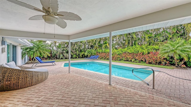 view of swimming pool featuring ceiling fan and a patio area