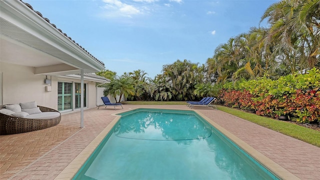 view of swimming pool featuring a patio area