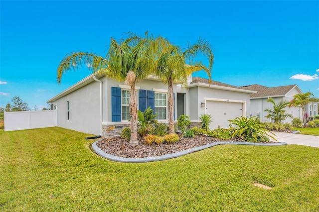 view of front of home with a front yard and a garage