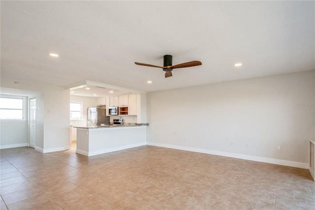 unfurnished living room with ceiling fan