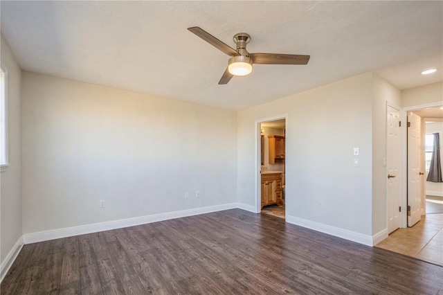 empty room with dark wood-type flooring and ceiling fan