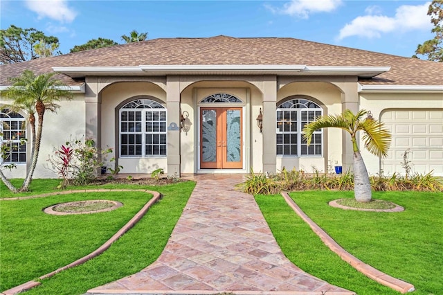 doorway to property featuring a garage and a lawn