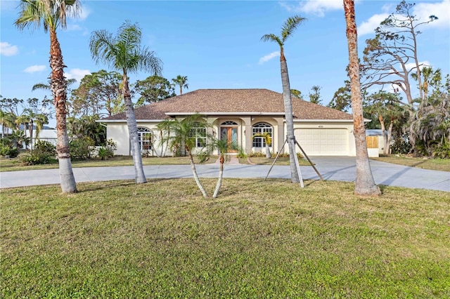 view of front of property with a front lawn and a garage