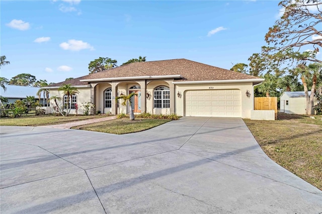 view of front of house featuring a garage and a front yard