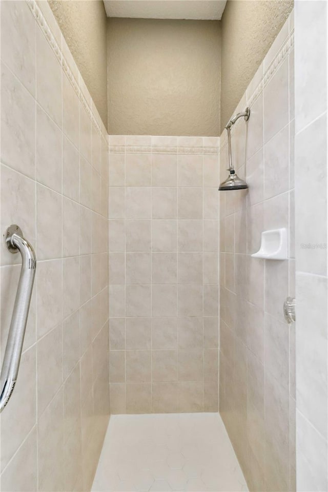 bathroom with a tile shower