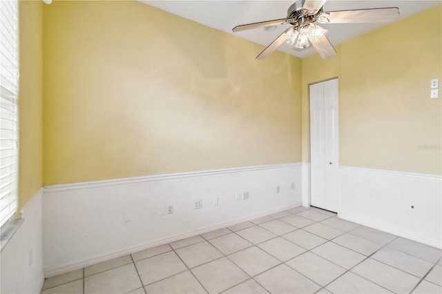 unfurnished room featuring ceiling fan and light tile patterned floors