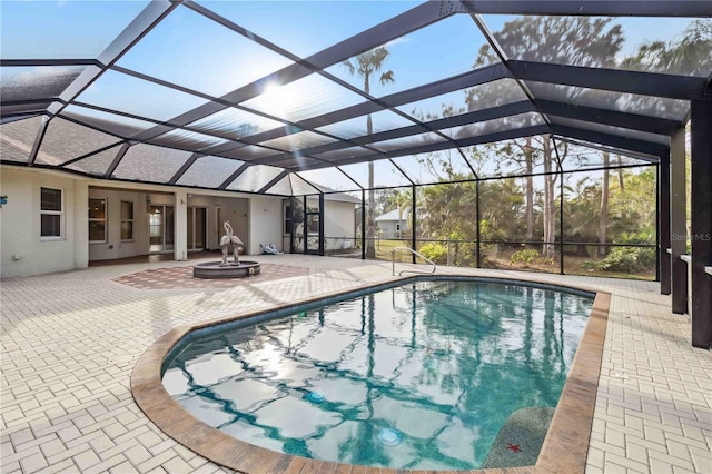 view of swimming pool with a lanai and a patio area