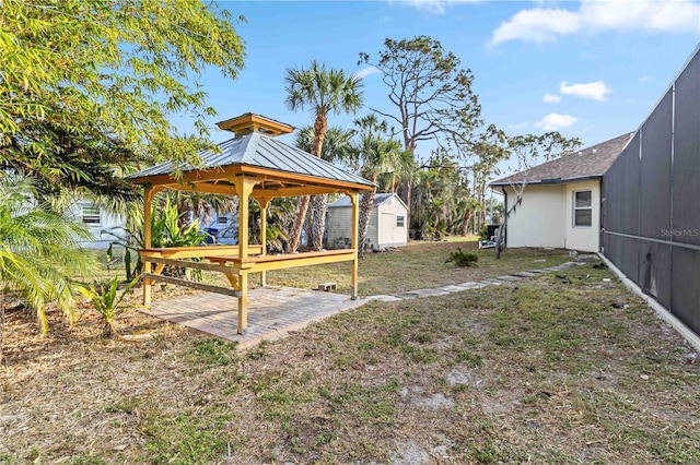 view of yard featuring a gazebo, a storage shed, and a patio