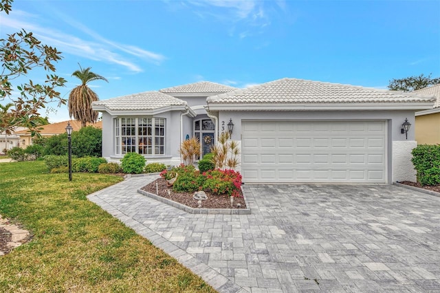 view of front of property with a front yard and a garage