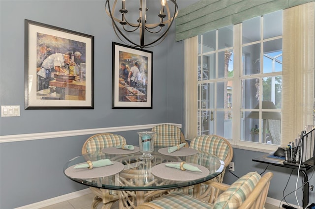 tiled dining room with a notable chandelier