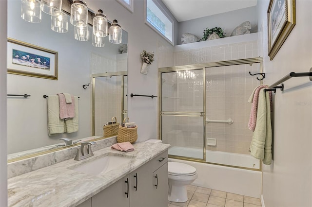 full bathroom featuring bath / shower combo with glass door, toilet, vanity, and tile patterned flooring