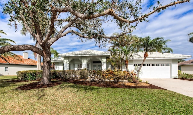 view of front of house with a garage and a front lawn