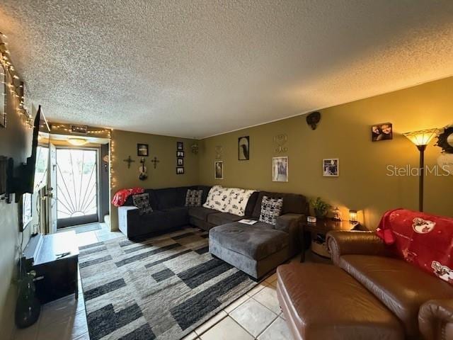 tiled living room featuring a textured ceiling