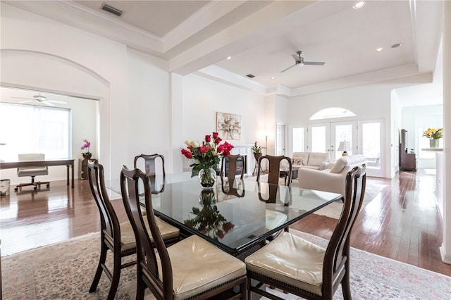 dining area featuring french doors, ceiling fan, crown molding, and light wood-type flooring