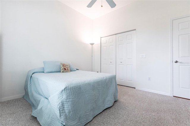 bedroom with lofted ceiling, carpet floors, a closet, and ceiling fan