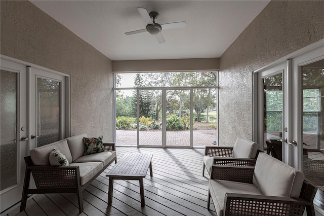 sunroom / solarium with ceiling fan and french doors