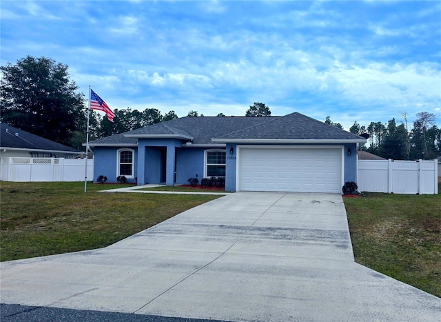 ranch-style home featuring a garage and a front lawn