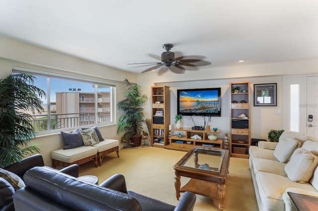 carpeted living room with a ceiling fan