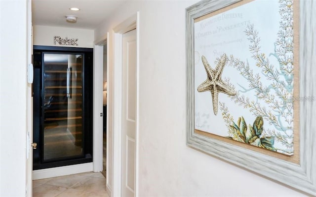 hallway featuring recessed lighting and light tile patterned flooring