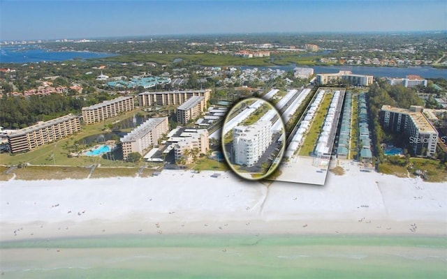 aerial view with a water view, a view of city, and a beach view