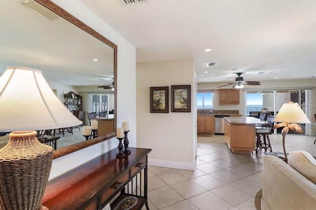 interior space featuring baseboards, light tile patterned flooring, visible vents, and recessed lighting