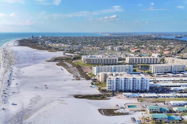 drone / aerial view featuring a view of city, a water view, and a beach view