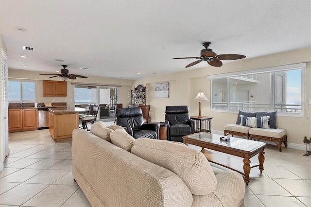 living area with light tile patterned floors, baseboards, visible vents, and recessed lighting