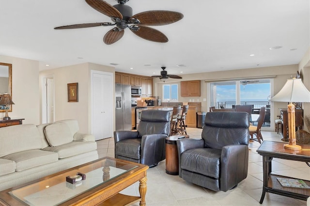 living area featuring light tile patterned floors, a ceiling fan, and recessed lighting