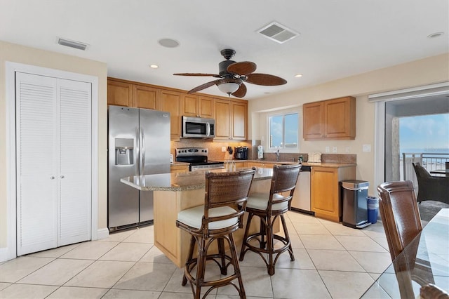 kitchen with light tile patterned floors, visible vents, and stainless steel appliances