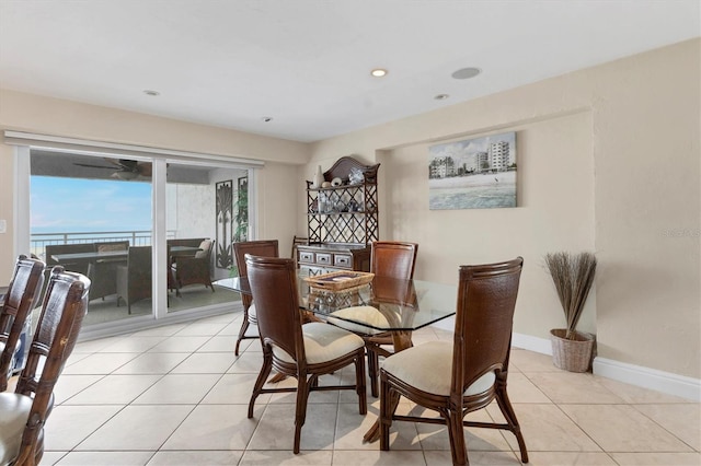 dining space featuring recessed lighting, light tile patterned flooring, and baseboards