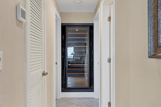 hall with light tile patterned floors