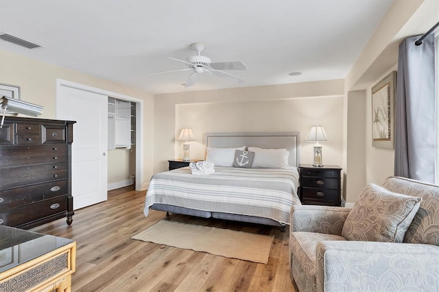 bedroom with a ceiling fan, visible vents, baseboards, a closet, and light wood finished floors