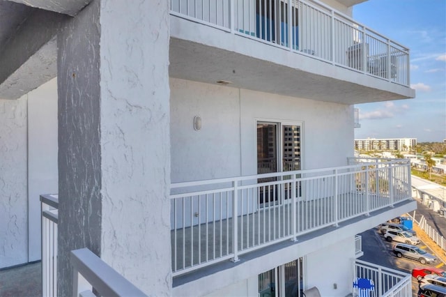 view of side of home with a view of city and a balcony