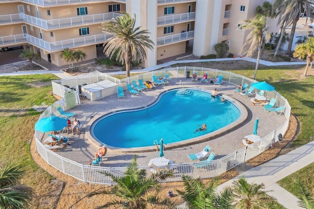 community pool featuring a patio area and fence