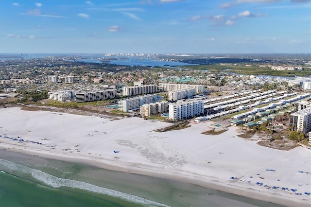 aerial view featuring a view of the beach, a water view, and a city view