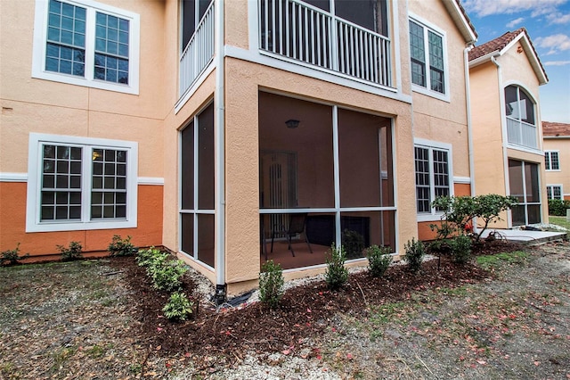 view of side of home featuring a sunroom