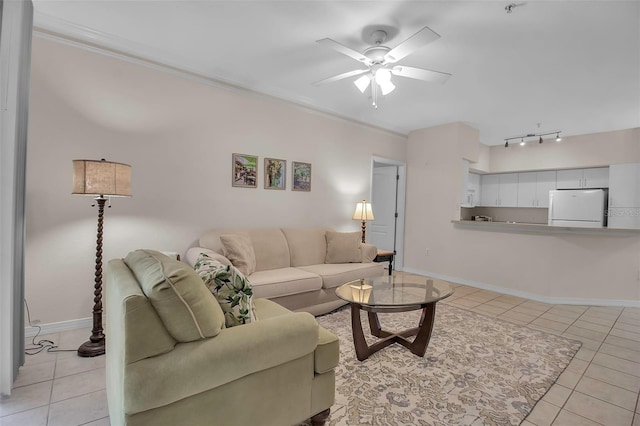 living room with crown molding, ceiling fan, and light tile patterned floors