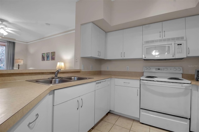 kitchen featuring light tile patterned flooring, sink, white cabinets, and white appliances