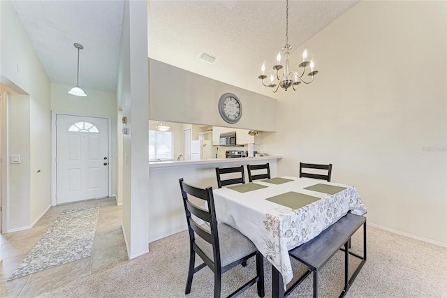 dining space featuring high vaulted ceiling, a notable chandelier, and a textured ceiling