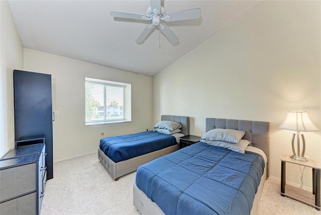 carpeted bedroom with vaulted ceiling and ceiling fan