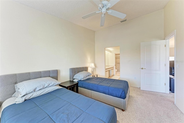 carpeted bedroom featuring lofted ceiling, ensuite bath, and ceiling fan