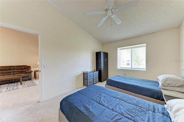 bedroom with ceiling fan, vaulted ceiling, a textured ceiling, and carpet flooring