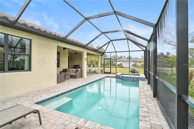 view of swimming pool with ceiling fan, outdoor lounge area, an in ground hot tub, glass enclosure, and a patio