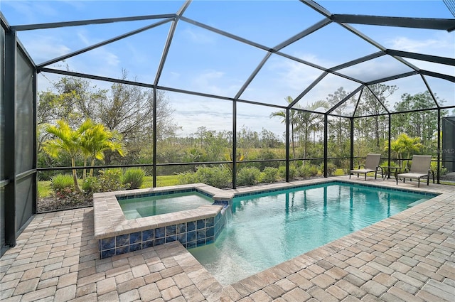 view of swimming pool featuring glass enclosure, an in ground hot tub, and a patio