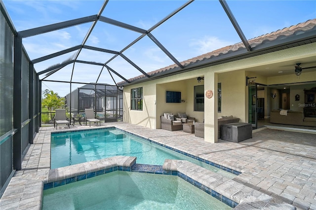 view of swimming pool with ceiling fan, glass enclosure, outdoor lounge area, and a patio