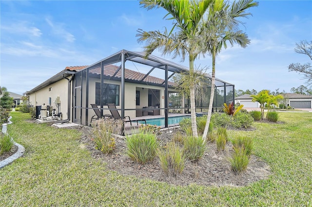 back of property featuring a lawn and glass enclosure