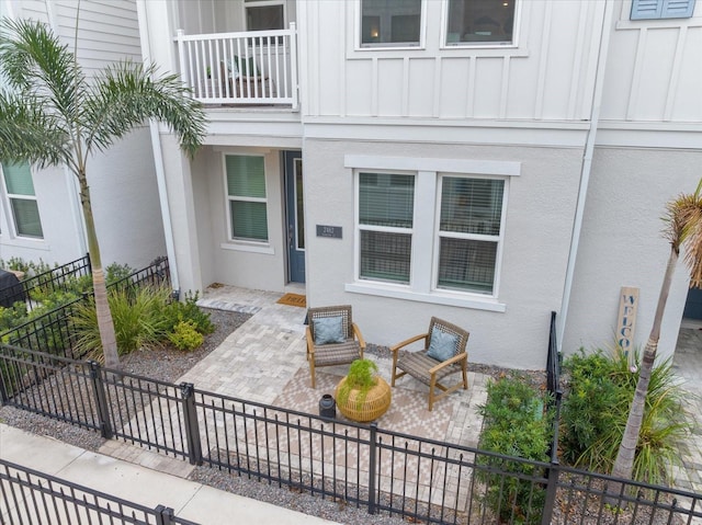 doorway to property featuring a balcony and a patio